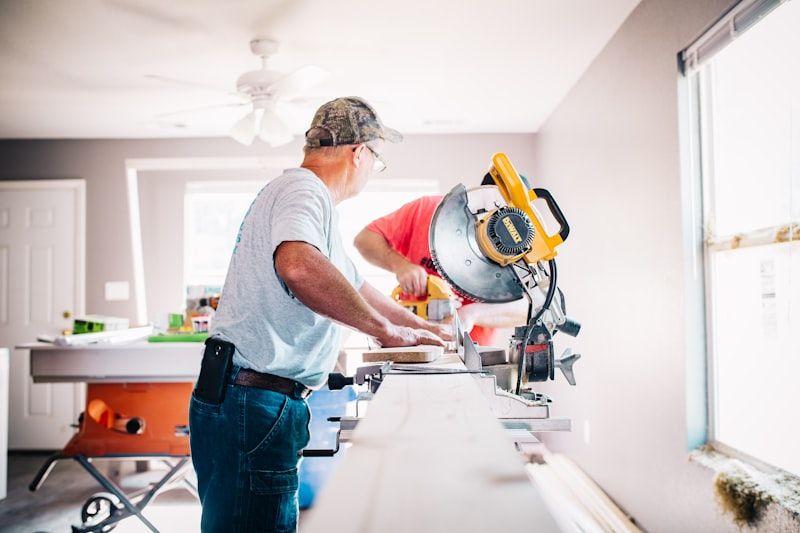 Two joiners cutting timber during a home renovation